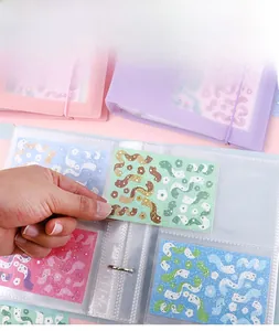 Macro view of macaron color sticker binder with clear pockets and elastic strap closure
