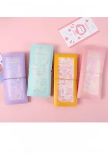 Close-up of macaron color sticker storage books with elastic bands in four soft pastel tones