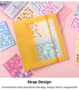 Detail of yellow translucent binder with orange elastic strap closure and inner sleeves