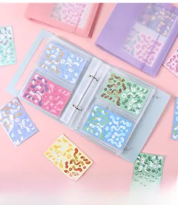 Detail of colorful mini loose-leaf binder with metal rings and clear inner pockets