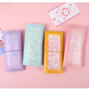 Detail of four macaron-colored translucent PP sticker storage books with elastic bands