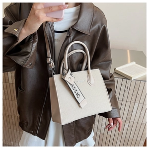 Detail of luxury off-white handbag with CLASSIC scarf handle and woven texture