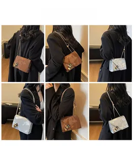 Detailed views of crossbody chain bag with marble pattern and metal lock worn by model