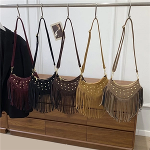 Bohemian suede crossbody bag with gold rivets and long fringe in multiple colors