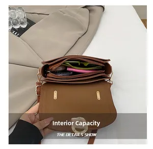 Detail shot of a brown vintage leather shoulder bag showing organized interior compartments