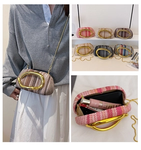 Detailed view of woven box clutch bag with gold metal handle in various colors