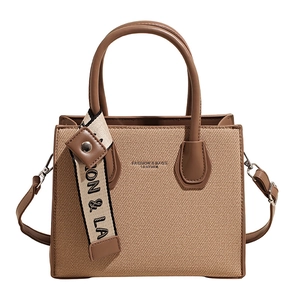 Luxury contrast color canvas tote bag with leather trim and decorative charm tag
