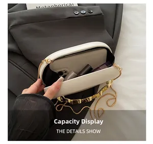 Top view of white wavy leather evening bag showing spacious interior with phone and makeup