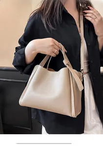 Détail du sac à main en cuir grainé abricot avec poignées et bandoulière réglable