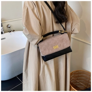 Detail of quilted crossbody bag with suede-like finish and golden twist lock closure