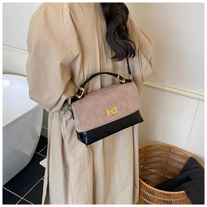 Detail of quilted leather handbag with pink suede flap and gold rotary clasp lock