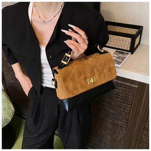 Detail of vintage quilted handbag featuring brown suede contrast and golden turn-lock