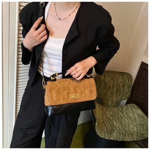 Close-up of quilted contrast bag with golden turn-lock and brown matte suede details