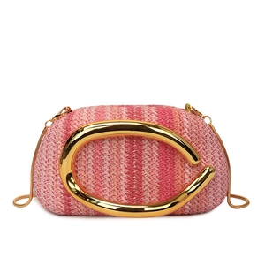 Pink woven round box bag with bold golden C-shaped handle and elegant chain strap