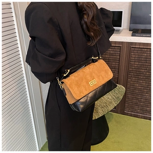 Detailed shot of two-tone quilted shoulder bag with suede top and gold twist lock
