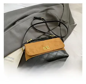 Detail of contrast stitching and texture on vintage quilted flap bag with gold metal lock