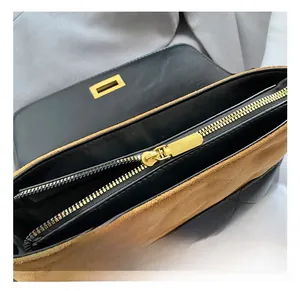 Detail of the high-quality gold zipper and metal lock on the quilted leather bag