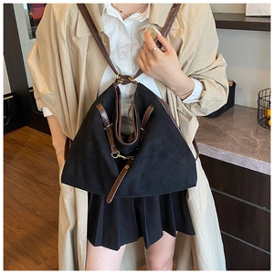 Détails du sac à dos noir mat avec sangles en cuir marron et boucles dorées en métal