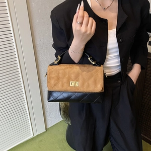 Quilted crossbody bag in brown suede and black leather with gold twist lock on model