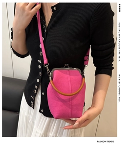 Detail of rose pink canvas shell bag featuring vintage kiss-lock and wooden handle