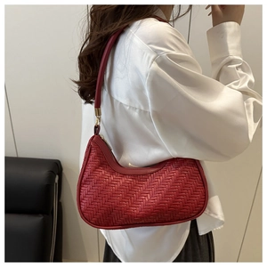 Detailed view of dark red woven hobo bag showing intricate texture and gold hardware