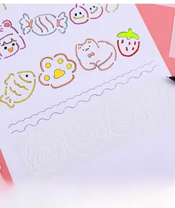 Detail of white flexible plastic drawing stencils with cartoon patterns and wavy edges