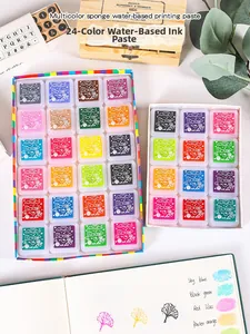 Detail shot of 24-color water-based ink pads with wooden stamps and creative DIY journal
