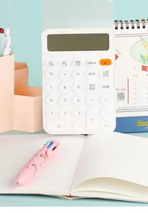 Macro detail of white desktop calculator with round buttons and LCD screen on office desk