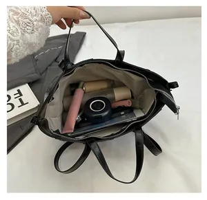 Spacious interior of retro black tote bag with cosmetics and daily items storage