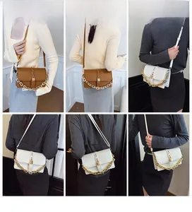 Detail shots of stylish crossbody bag with gold chain and strap in brown and white