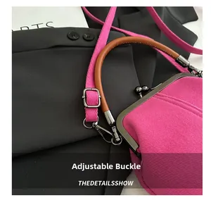 Detail of pink denim shell bag featuring adjustable shoulder strap with metal buckle