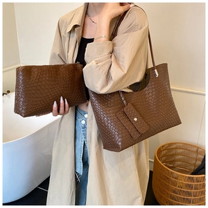 Brown woven texture tote bag and matching clutch set shown with a lifestyle model