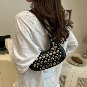 Black vintage crescent shoulder bag with silver studs and glossy leather finish