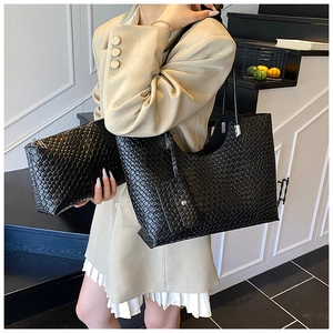 Detail of black woven texture on tote bag set featuring large capacity and matte finish
