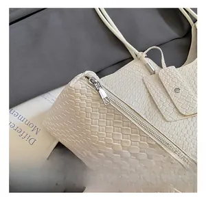 Close-up of off-white woven texture and silver metal zipper on stylish tote bag