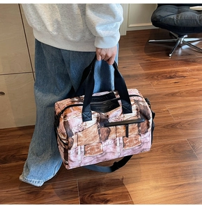 Detail der großen Reisetasche mit Vintage-Jeans-Print und schwarzem Logo-Patch-Design