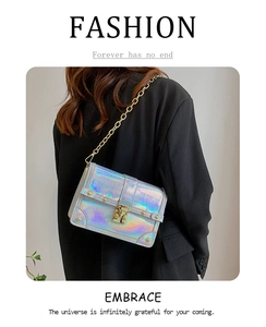 Close-up of holographic crocodile texture on a small square crossbody bag with gold chain