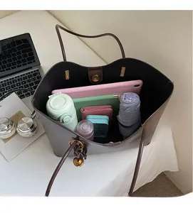 Spacious interior of dark brown leather tote bag with magnetic clasp and daily essentials