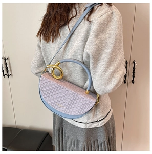 Blue and purple semi-circular crossbody bag with round golden handle on model