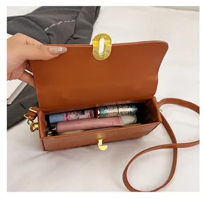 Interior view of brown PU leather crossbody bag showing spacious storage for cosmetics