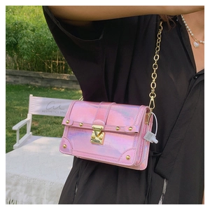 Close-up of pink iridescent crocodile pattern box bag with golden metal lock and chain