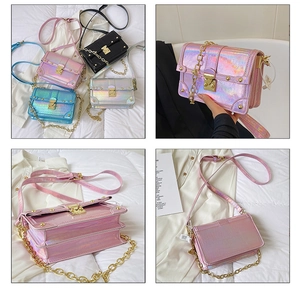 Detail view of stylish laser-textured crossbody bag with golden lock and metal chain strap