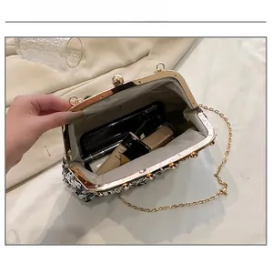 Interior view of sequin evening clutch showing capacity for smartphone and lipstick