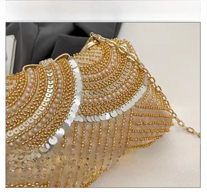 Macro view showing intricate sequin embroidery and pearl details on the luxury evening clutch