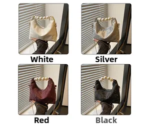 Detail view of four textured handbags with pearl chains in white, silver, red, and black