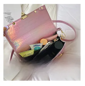 Macro detail of holographic pink crossbody bag showing spacious interior compartment