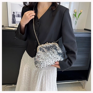 Detail of silver sequin evening bag with elegant pearl clasp and gold chain strap