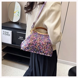 Dettaglio della borsa da sera con paillettes viola, manico in legno e chiusura in metallo