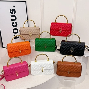 Quilted crossbody bag with bamboo handle and gold lock, shown in multiple fashion colors