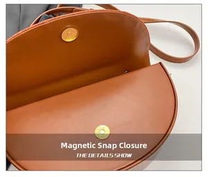 Detail showing the magnetic snap closure and interior of the brown saddle shoulder bag